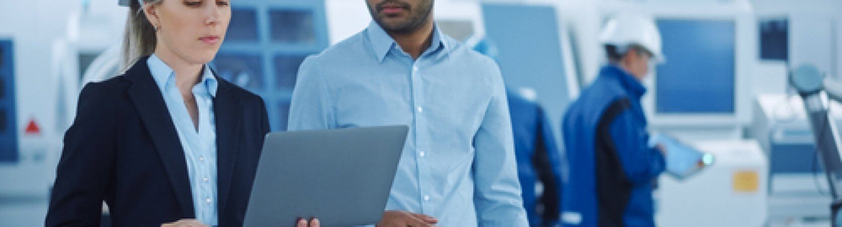 Planning engineers assessing a project on a laptop